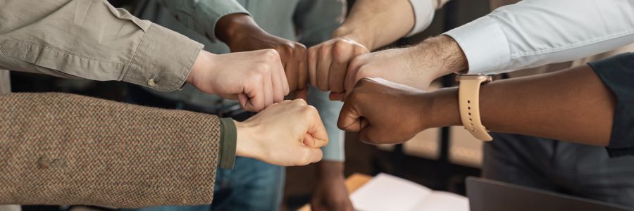 diverse business people giving fist bump in circle