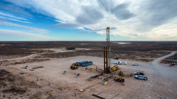 Drone View Of An Oil Or Gas Drill Fracking Rig Pad with Beautiful Cloud Filled Sky