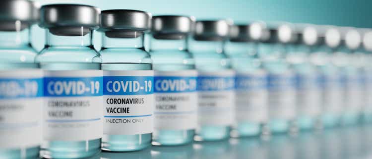 Row of Coronavirus vaccine flasks. Shallow depth of field.