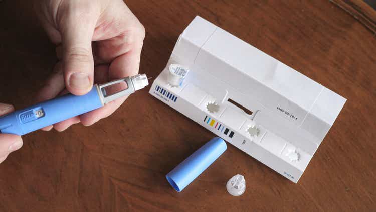 obese fat man preparing Semaglutide Ozempic injection control blood sugar levels