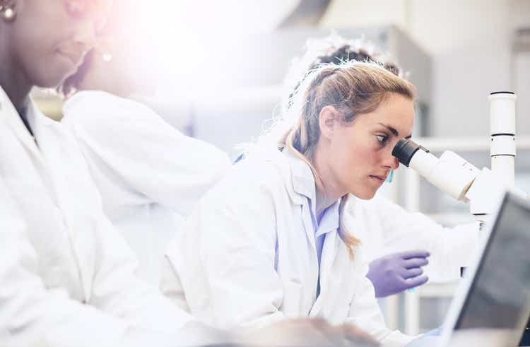 Scientist Looking Through the Microscope