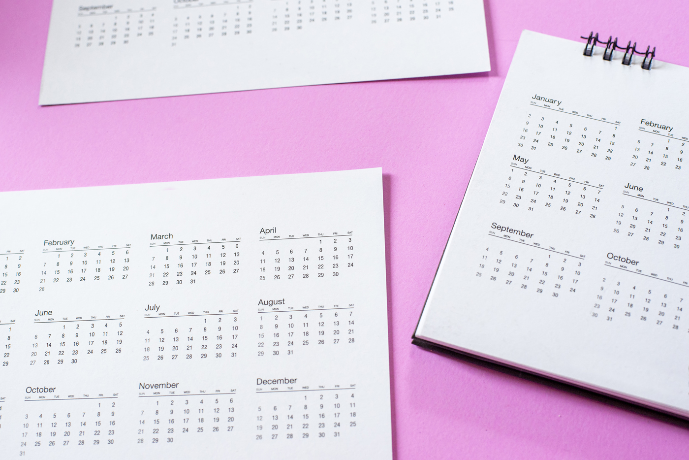 Calendar pages on pink background