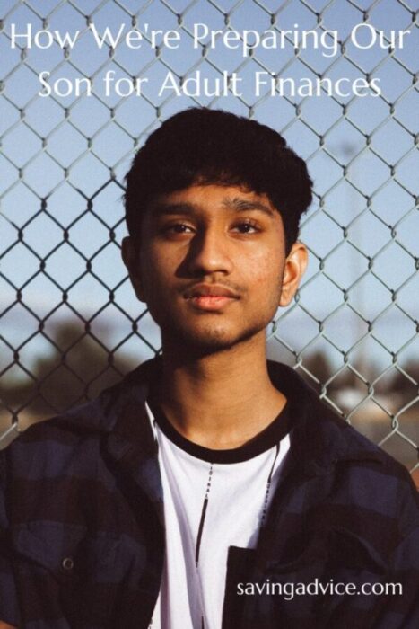 Teenage boy standing with a chain link fence behind him.