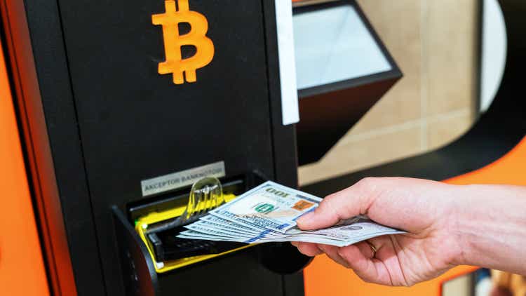 Atm machine bitcoin cryptocurrency. Usd hundred money payment on virtual crypto currency btc wallet. Woman withdraw american dollar bill money. Atm machine finance and technology concept.