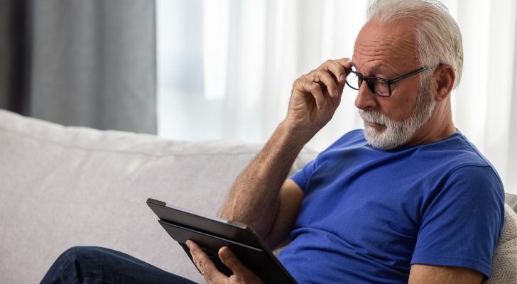 A 65-year-old man who plans to retire at age 70 looks over the investments in his IRA. 