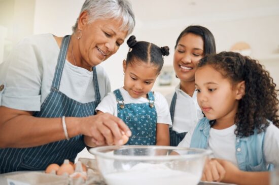 grandma baking with three granddaughters